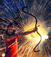 With fireworks in the backdrop, an actor poses as Lord Rama at the Parade Ground in Sector 17, Chandigarh, on Wednesday