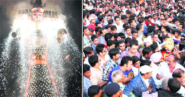 An effigy of Ravana goes up in flames at the Parade Ground in Dehradun on Wednesday; and people try to enter the venue to witness the celebrations.
