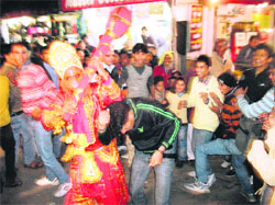 Chandar Bhan, who has been playing the role of Hanuman for the past 43 years, gives blessings to devotees during the Dasehra celebrations in Mussoorie on Wednesday.