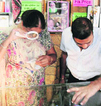 Forensic experts collect fingerprints from a showroom at Jagraon on Wednesday.