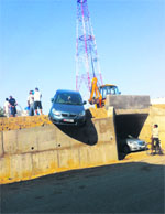 A car balances precariously on the edge of a flyover in Phagwara on Wednesday. Photo: Ashok Kaura