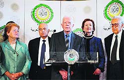 Former US president Jimmy Carter (C) addresses a joint press conference with international peace envoy for Syria Lakhdar Brahimi (R) at the Arab League headquarters in Cairo on Wednesday