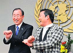 UN Secretary-General Ban Ki-moon (L) practices some Gangnam Style dance steps with South Korean singer Psy at the UN headquarters in New York