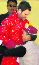 Rahul Gandhi is presented traditional attire at a rally in Keylong on Thursday. 