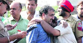 Relatives of the woman, who was crushed to death by a train, console each other in Jalandhar on Thursday.