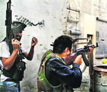 Free Syrian Army soldiers fire towards regime loyalists in the neighbourhood of northern city of Aleppo