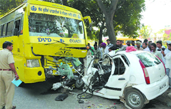 The ill-fated car and the private bus that collided on the Bathinda-Goniana road on Friday. Tribune photo: Pawan Sharma