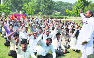 Members of the Rice Mill Workers Union hold a protest in Karnal on Friday. 