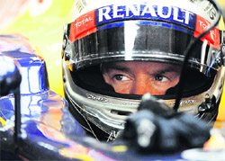 Red Bull Formula One driver Sebastian Vettel of Germany sits in his car during the second practice session of the Indian F1 Grand Prix.