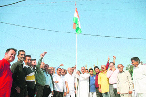 BJP leaders and activists hoist the Tricolour during Accession Day celebrations in Jammu on Friday.