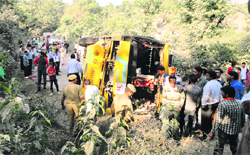 Police personnel inspect the accident site near Simbal Choya in Reasi on Friday. A Tribune Photograph