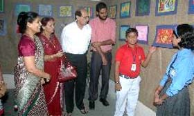 Visitors have a look at the paintings by class VI students of DAV School on Saturday.
