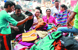 With winter approaching, people purchasing woollens at a shop in Dhobi Bazaar in Bathinda on Sunday.
