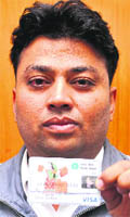 Shiv Kumar shows his ATM card. 