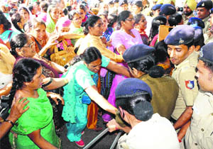 Protesting anganwari workers from Punjab being stopped by the police in Sector 30, Chandigarh, on Sunday.