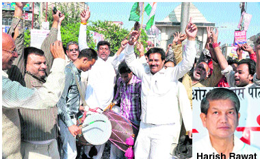 Supporters of Harish Rawat dance in Haridwar on Sunday.
