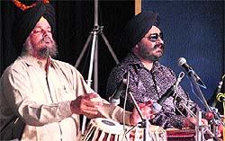 Vocalist Iqbal Singh performs at the Hemant Utsav in Jalandhar on Sunday; and (below) Violinist R Sreedhar giving his peformance
