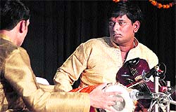 Vocalist Iqbal Singh performs at the Hemant Utsav in Jalandhar on Sunday; and (below) Violinist R Sreedhar giving his peformance