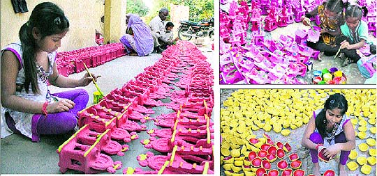 Little girls working on their Divali creations in Jalandhar on Sunday