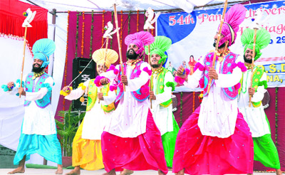 Students perform bhangra during the 54th Inter-Zonal Youth Heritage Festival organised by Panjab University at GGSD College in Hoshiarpur. 