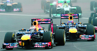 Red Bulls Sebastian Vettel (front) and Mark Webber led the race right from the begining at BIC on Sunday; victorious Vettel (down) at the podium.