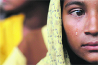 A woman displaced by the recent violence in the Kyukphyu township cries after arriving at the  Thaechaung refugee camp near Sittwe. 