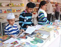 Children are happy scrolling through activity books, illustrated books, rhymes and lessons enrolled in CDs, DVDs and pen drives at the book fair. 
