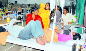 Two patients share a bed at the General Hospital, Sector 6, Panchkula, on Monday.