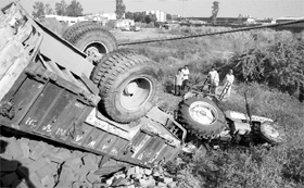 A tractor-trailer lies overturned after it met with an accident on the Dera Bassi-Barwala road on Monday.