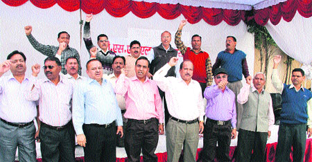 BSNL employees hold a demonstration in support of their demands in Dehradun on Monday.