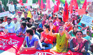 Labour unions from Haridwar stage a dharna in front of the Secretariat in Dehradun on Monday.