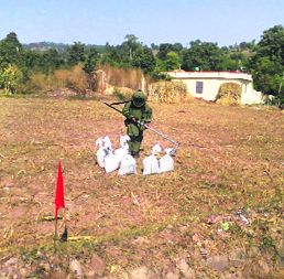 A security officer in protective gear defuses the IED found on the Jammu-Poonch national highway on Monday.