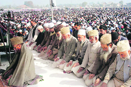 People offer prayers at the Eidgah in Srinagar on Monday.; families make the most of a holiday at amusement rides at a childrens park in Srinagar on Monday. 