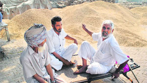 Farmers wait for their paddy to be procured at the Bathinda grain market.