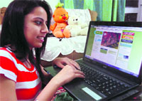 A girl makes online booking for henna application ahead of Karva Chauth in Sector 28, Chandigarh.