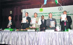 Chief Minister Vijay Bahuguna releases a souvenir after inaugurating the 46th session of the International Poplar Commission at the Forest Research Institute in Dehradun on Tuesday