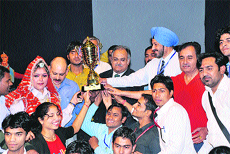 Haryana Speaker Kuldeep Sharma (wearing black coat) and Kurukshetra University VC Lt-Gen DDS Sandhu (wearing blue turban) with the team winning the overall running trophy in the 27th four-day Ratnawali - 2012 which concluded in the Kurukshetra University auditorium on Tuesday.