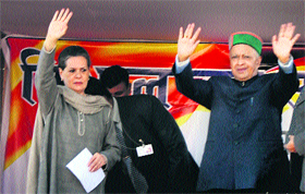Congress president Sonia Gandhi and HPCC chief Virbhadra Singh wave to the crowd at a political rally in Kangra on Tuesday.