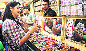 With a few days to go for Karwa Chauth, a young woman takes a look at a bangle stall in Jalandhar on Tuesday. 