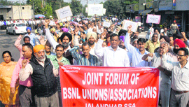 Members of the Joint Forum of the BSNL unions and associations hold a protest march from the BSNL office to the Divisional Commissioner office in Jalandhar on Tuesday. 