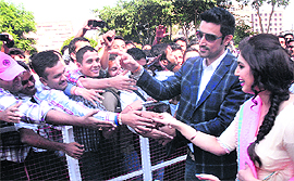 Kunal Kapoor and Huma Qureshi, star cast of the upcoming Hindi film Luv Shuv Tey Chicken Khurana, shake hands with students near Jalandhar on Tuesday.