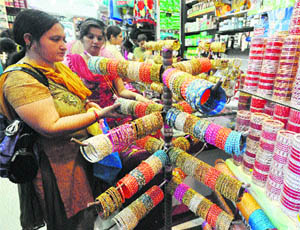 Women buy bangles from a shop in Jammu on Tuesday ahead of Karva Chauth, which will be celebrated on November 2. 