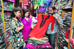 A shopkeper displays a long woollen kurti at Nai Basti market in Jammu on Tuesday. tribune photo: Inderjeet Singh