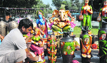 A vendor displays works of art at an exhibition in Kala Kendra, Jammu, on Tuesday. Tribune photo: Anand Sharma