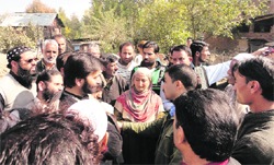 Jammu and Kashmir Liberation Front chairman Yasin Malik with the affected families in Sopore. A tribune photograph