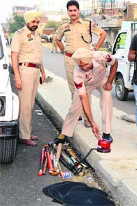 A policeman arranges weapons recovered from vehicles in Ludhiana on Tuesday