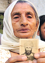 Veeran Wali, who shifted to Ludhiana after the riots, shows a photo of her son who was killed in Delhi.