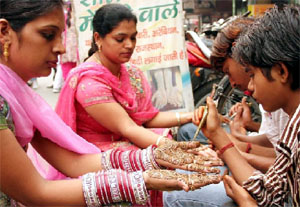 Women get henna applied on their hands in Dhobi Bazaar ahead of the festival of Karva Chauth which will be celebrated on November 2.