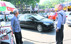 A private guard oversees a parking lot in Sector 19, Chandigarh, on Wednesday. tribune photo: Manoj Mahajan