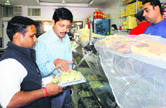 Health Department officials collect samples of sweets from a shop in Sector 46, Chandigarh, on Wednesday. tribune photo: parvesh chauhan 